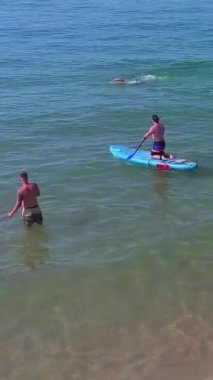 Aerial Footage of people are Relaxing and swimming in the Ocean Water at Beach of Bournemouth England UK