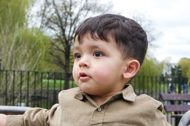 Şirin Asyalı Pakistanlı Bebek İngiltere 'nin Luton kasabasındaki Savaş Parkı' nda eğleniyor.