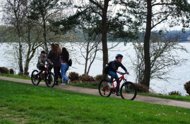 Milton Keynes, İngiltere - 9 Nisan 2023: Willen Gölü 'ndeki insanlar. Willen Lake, Milton Keynes, Buckinghamshire 'da bulunan bir ziyaretçi merkezi.