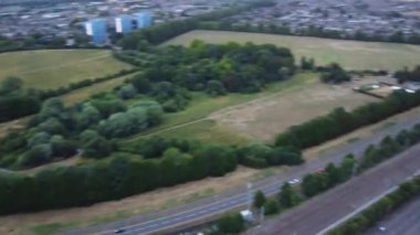 Aerial View and high angle footage of British Railways Trains on Tracks, Passing Through Luton Town of England at Leagrave Station, Cloudy Day