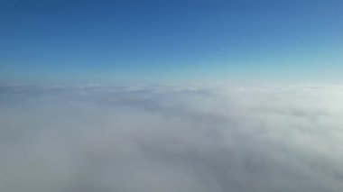 Most Beautiful Aerial View of Above the Clouds in the Morning. Dramatically fast moving clouds