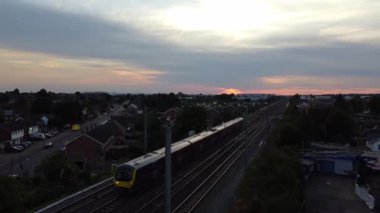 Aerial footage and high angle view of Train on Tracks at Central Luton Railway Station and City Centre of Luton Town of England UK