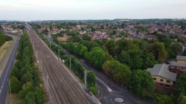 Aerial footage and high angle view of Train on Tracks at Central Luton Railway Station and City Centre of Luton Town of England UK