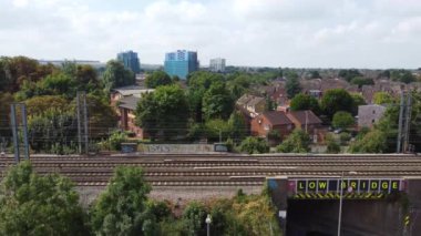 Aerial view of British Town Centre of Luton England with Railway Station and Train on Track