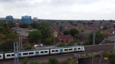 Aerial view of British Town Centre of Luton England with Railway Station and Train on Track