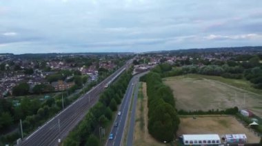 İngiltere 'nin Luton kasabası yakınlarındaki güneş batarken hızlı tren raylarda hareket ediyor.