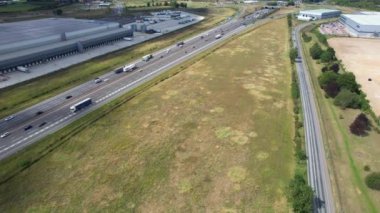 Bulutlu Öğleden Sonra Yoğun Trafikli İngiliz Otoyollarının Yüksek Açılı Görüntüleri. Görüntüler, İngiltere 'nin Luton şehrinde M1 kavşağında İHA' nın kamerasıyla 15 Ağustos 2023 'te çekildi.