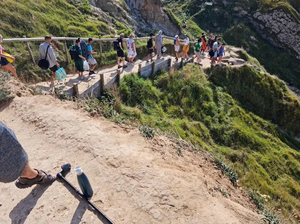 İngiltere 'nin Durdle Door Tepeleri' ndeki insanlar Büyük Britanya, İngiltere. Görüntü İHA 'nın kamerasıyla 9 Eylül 2023' te çekildi.