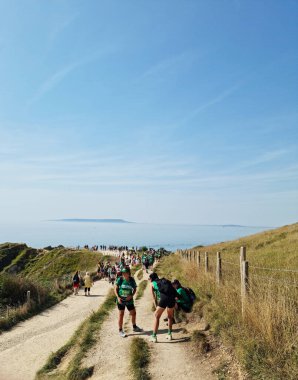 İngiltere 'nin Durdle Door Tepeleri' ndeki insanlar Büyük Britanya, İngiltere. Görüntü İHA 'nın kamerasıyla 9 Eylül 2023' te çekildi.