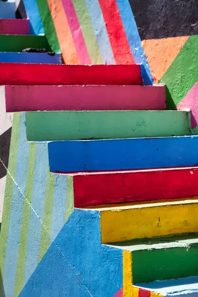 stock image A view of a staircase with steps painted in bold colors and geometric patterns adding a playful dimension