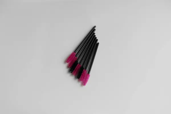 Pink and black eyelashes brush isolated on white background. Brush for combing eyelashes. brush for straightening eyelashes and eyebrows.