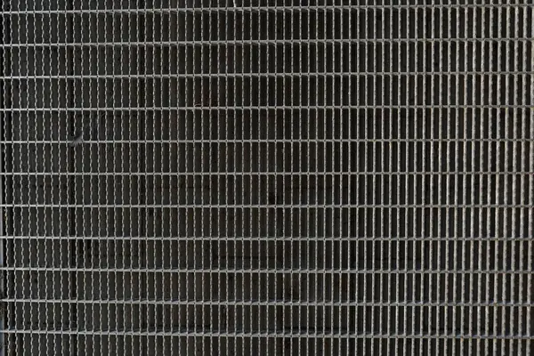 stock image A background image of a corridor built from gray steel grating panels.