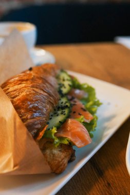 Croissants with soft cheese, salted salmon and green salad. Love clipart