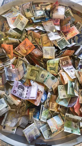 Finansal bağlamda gösterilen renkli banknot koleksiyonu. Döviz çeşitliliği ve küresel para kavramlarının gösterilmesinde kullanışlıdır.