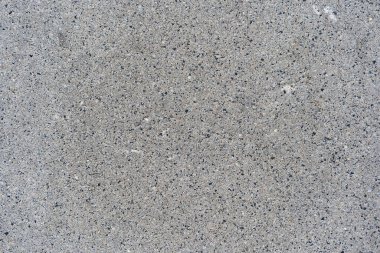 Kaba gri beton yüzey görülebilir toplam ve pürüzlü doku, izole ve eşit ışıklandırılmış. Arkaplan, tasarım projeleri veya inşaatla ilgili görsel içerik için uygundur.