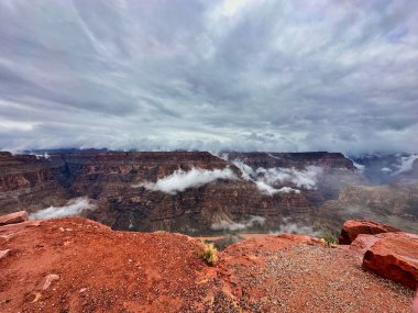 Up in the clouds at the West Rim of the Grand Canyon. Guano Point full of clouds on a cold wet foggy day at one of the seven wonders of the world. clipart