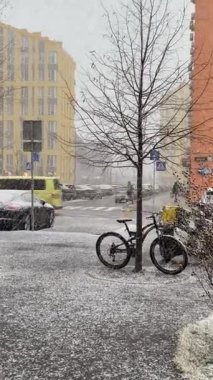 city bike with snow in the street, snowing in city, winter in Kyiv 
