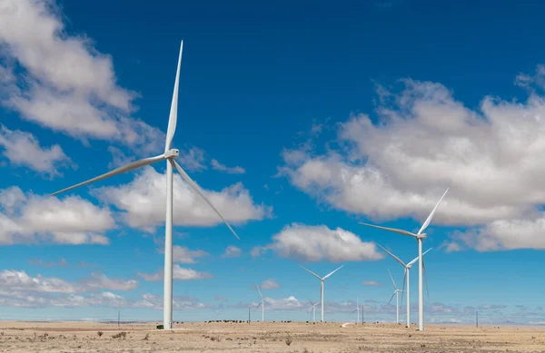 stock image Wind farm producing green energy under a beautiful blue sky with fluffy white clouds in New Mexico