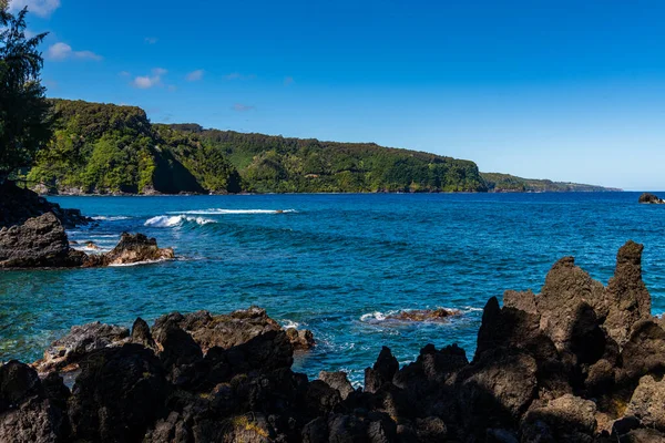 Volcanic rock formations along the shoreline of the Keanae Peninsula in Maui, Hawaii
