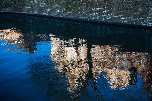 Traditional Dutch Buildings Reflected Abstract Rippled Blue Waters Canal Amsterdam — Stock Photo, Image