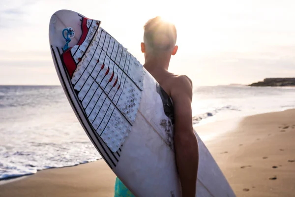 stock image close up of man running on the beach with his surfboard going surfing at summer with the sunset 