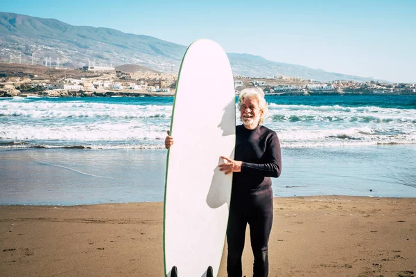 머리에 거침없는 상급생 미소짓고 나이가 남자가 잠수복을 재미있는 서핑을 활동적 — 스톡 사진