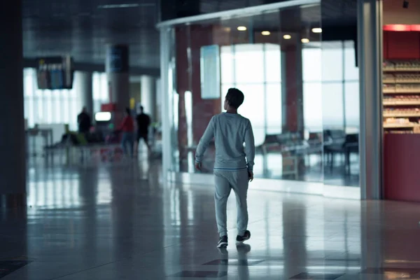 stock image alone man walking isolated in the airport - traveler boy and business man is going to fly and travel the world 