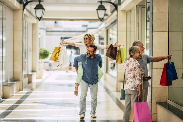 stock image group of four people and family go shopping together holding a lot of shopping bags after buy it - black friday or cyber monday and sales time 