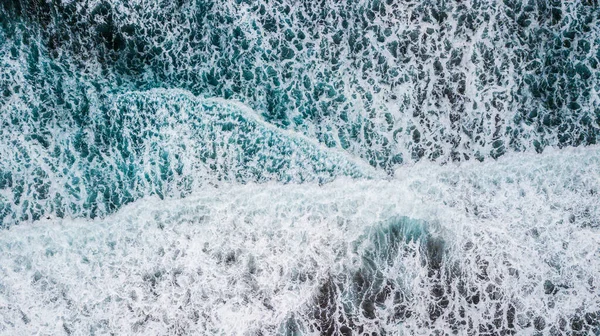 stock image beautiful and big blue and green waves breaking - pacific or Atlantic ocean - blue sea and great place to surf - above and top view from a drone 