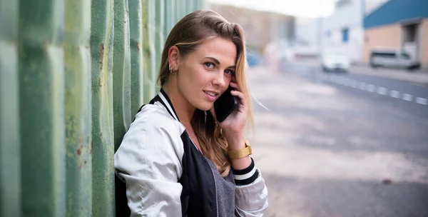 stock image beautiful woman or teenager talking with her boyfriend or friends with her phone on a urban street