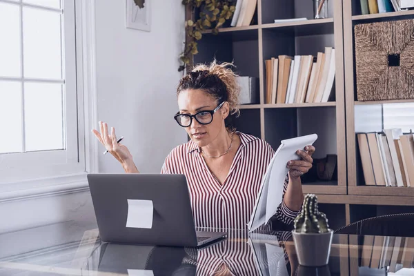 Disappointed female employee confused with bad internet connection or laptop breakdown at office. Frustrated businesswoman puzzled facing device operating problem at home work desk