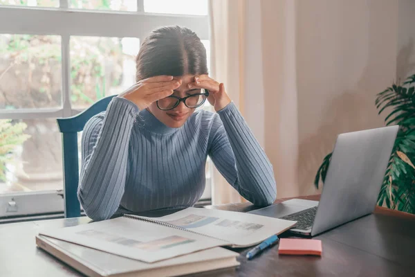 stock image Tired bored teenage girl school student feeling headache or fatigue doing homework at home. Exhausted depressed sick teenager studying alone worried about difficult education problems concept. 