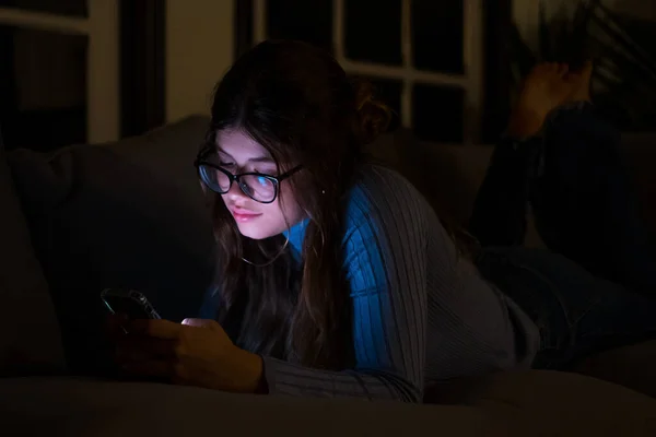 stock image One happy and insomniac your woman using phone late at night in the bedroom at home chatting. Online girl surfing the net revising social media. Technology concept using internet 