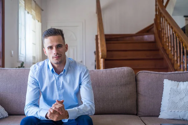 stock image Portrait of happy millennial man looking at camera relaxing at home. Copy space. Confident guy making picture sitting on couch in apartment. Close up   