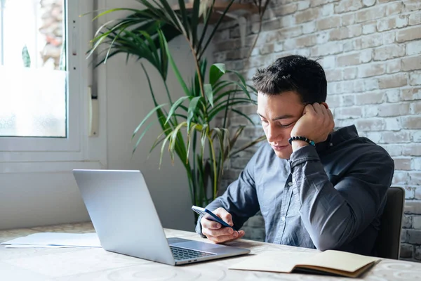 stock image Unhappy young man looking at phone, feeling nervous of bad device work, internet disconnection, lost data or inappropriate online content. Anxious male user dissatisfied with application or service.