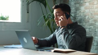 Konsantre olmuş yetenekli bin yıllık Kafkas işadamı bilgisayar kullanıyor, uzaktan iletişim kavramı kullanıyor..