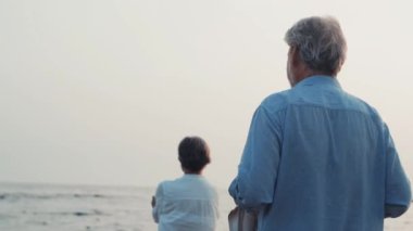 İki mutlu ve aktif yaşlının ya da emeklinin gün batımını seyrederken eğlenirken ve eğlenirken çekilmiş görüntüleri.