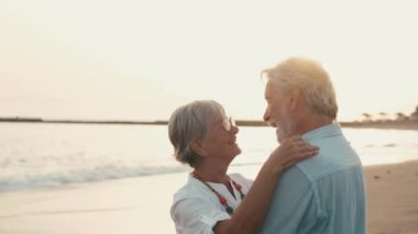 İki mutlu ve aktif yaşlının ya da emeklinin gün batımını seyrederken eğlenirken ve eğlenirken çekilmiş görüntüleri.