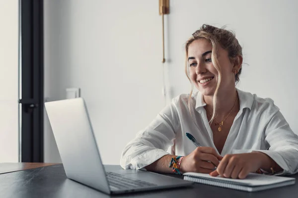 stock image Head shot pleasant happy young woman freelancer studying on computer at home. Attractive businesswoman studying online, using laptop software, web surfing information or shopping in internet store.