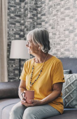 Face of senior caucasian hoary woman looking away deep in sad thoughts feels lonely close up portrait, recollect memories and life moments, depressed grandmother alone indoors, yearning for husband concept