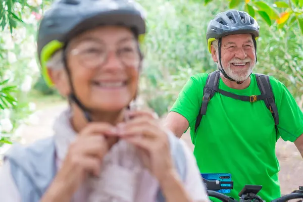 One old mature man riding a bike and enjoying nature outdoors having fun. Senior having a healthy and fit lifestyle.