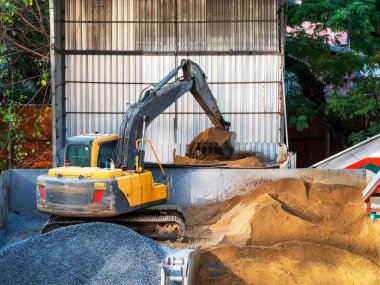 excavator in construction plant digging sand