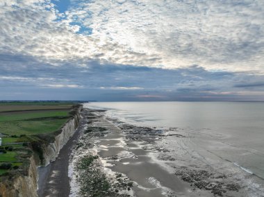 Aerial view taken with a drone showing the town of Quiberville in Normandy, the beach, the cliffs and the sea in good weather