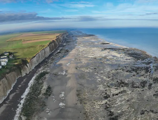 Aerial view taken with a drone showing the town of Quiberville in Normandy, the beach, the cliffs and the sea in good weather