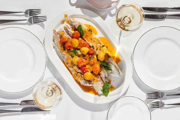 노란색의 토마토를 소스에 포도주와 과가벼운 접시에 이탈리아 약초를 곁들인 트라우트 — 스톡 사진