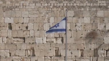 Flag of Israel with the Wailing Wall in the backgroundin Jerusalem