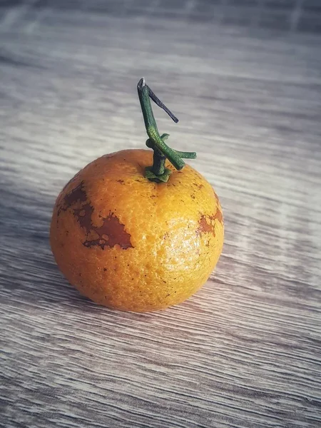 Zdjęcie Małej Pomarańczy Drewnianym Stole Mała Pomarańcza Zieloną Łodygę Bez — Zdjęcie stockowe