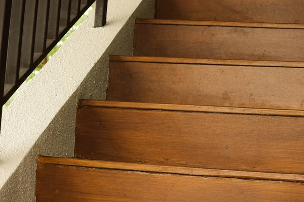 Wooden stairs with wooden railing in a building. The use of this wood gives the effect of a shady, warm and comfortable atmosphere.