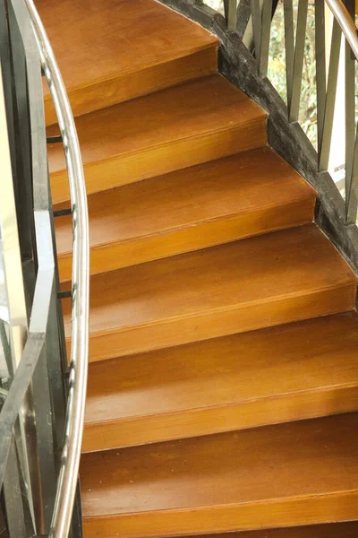 Wooden stairs with wooden railing in a building. The use of this wood gives the effect of a shady, warm and comfortable atmosphere.