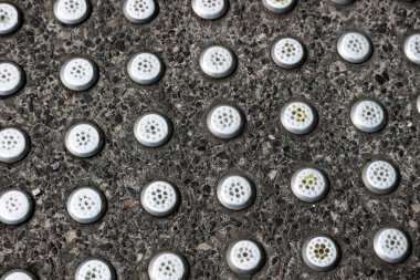 Guiding Block or guide way, which is a sign specifically for persons with disabilities, especially for those with visual impairments. The texture on the guiding block can be used by persons with disabilities to direct or warn.